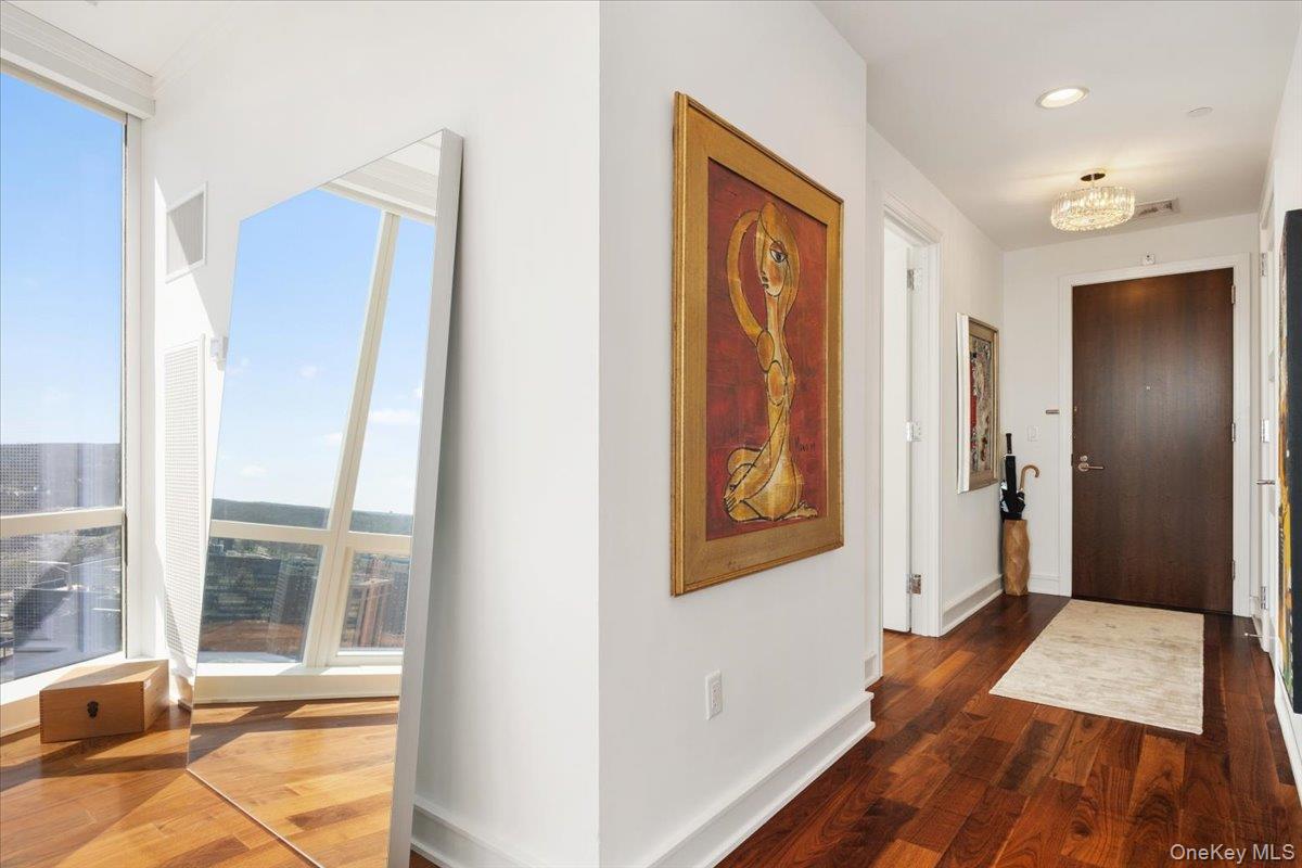 5 Renaissance Square, Unit PH 3E White Plains, NY 10601 - Photo 5 of 26 a view of a hallway with wooden floor and windows