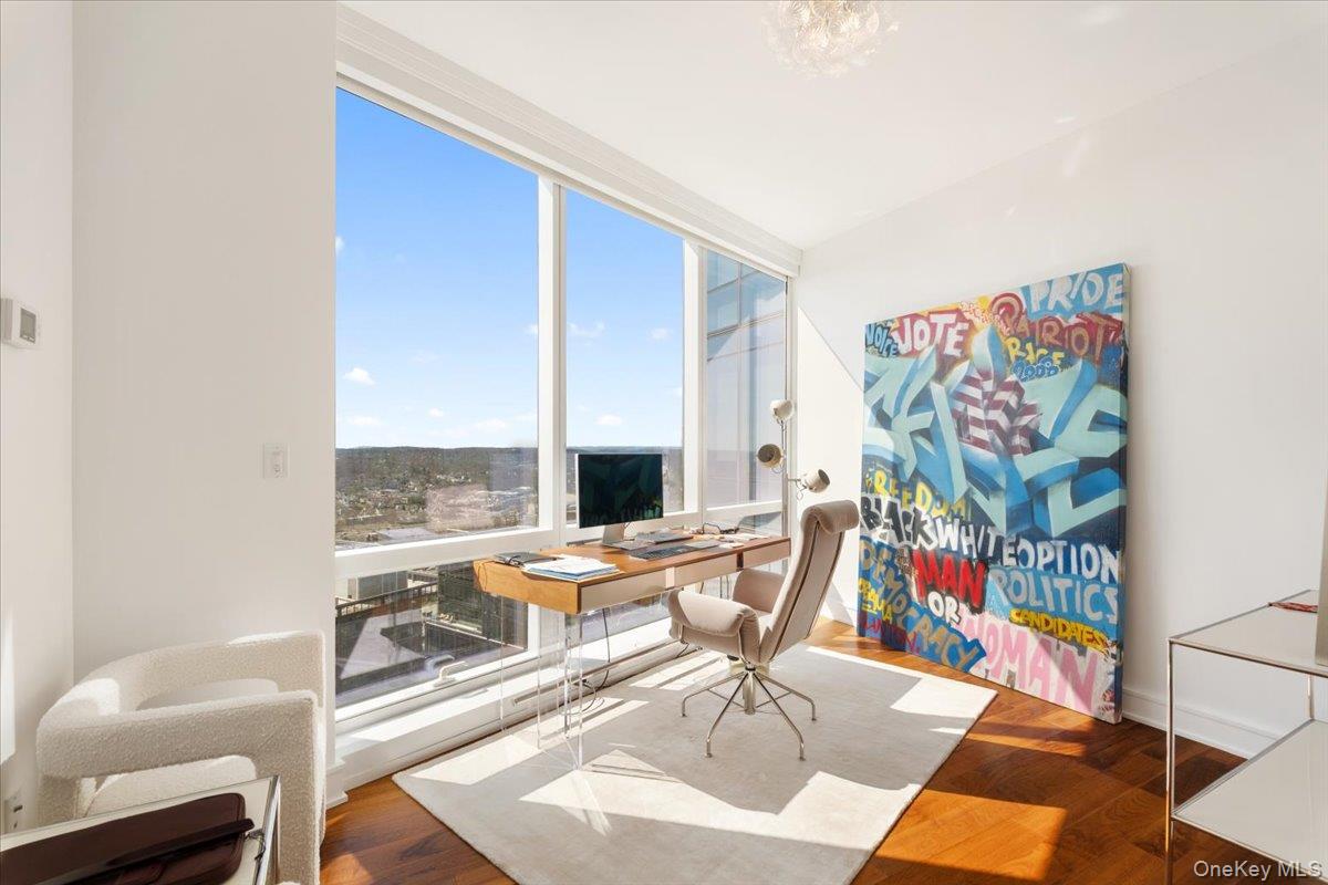 5 Renaissance Square, Unit PH 3E White Plains, NY 10601 - Photo 6 of 26 a living room with furniture and a floor to ceiling window
