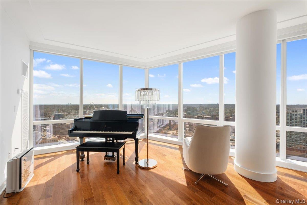 5 Renaissance Square, Unit PH 3E White Plains, NY 10601 - Photo 9 of 26 a living room with furniture and wooden floor