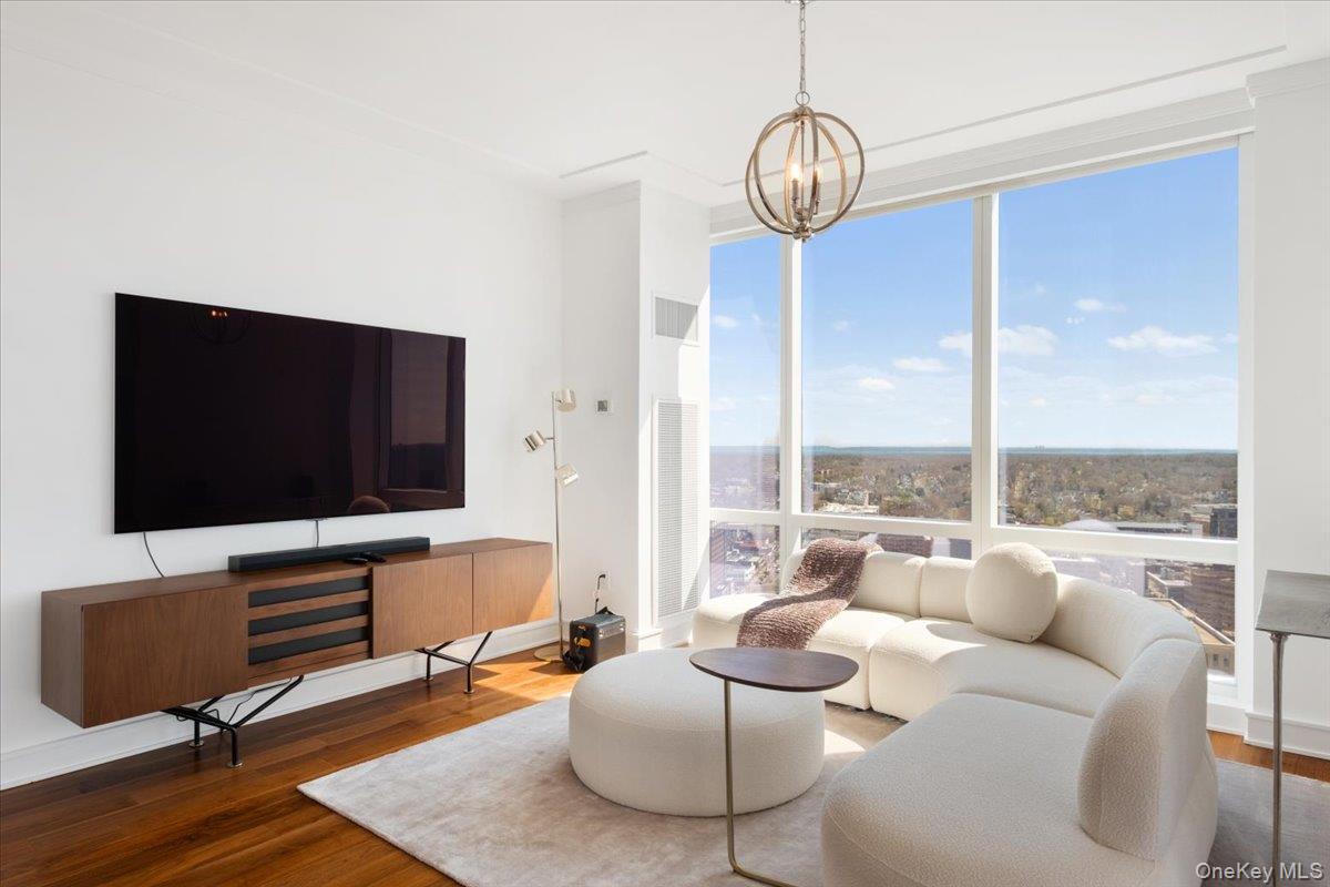 5 Renaissance Square, Unit PH 3E White Plains, NY 10601 - Photo 10 of 26 a living room with furniture and a flat screen tv