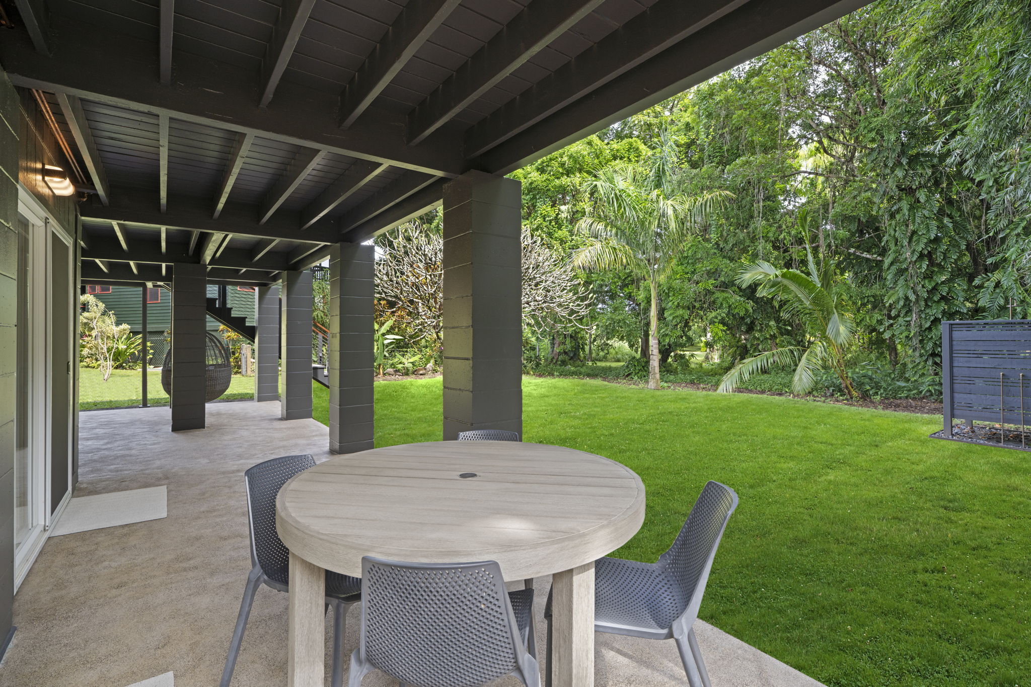4485 Pilikoa Street Hanalei, HI 96714 - Photo 21 of 28 a view of a patio with a table chairs and a backyard