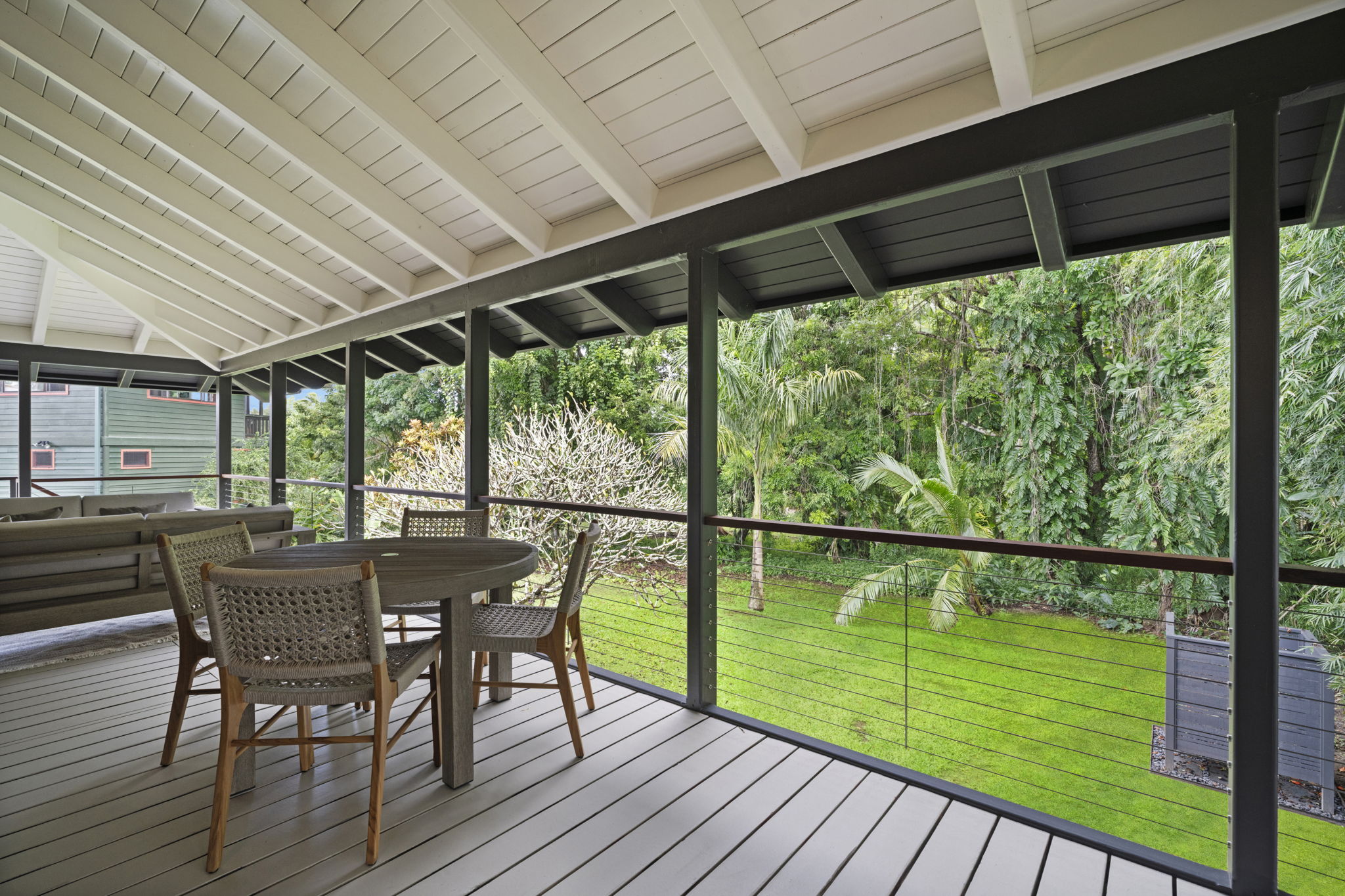 4485 Pilikoa Street Hanalei, HI 96714 - Photo 8 of 28 a patio with wooden floor a yard tables and chairs