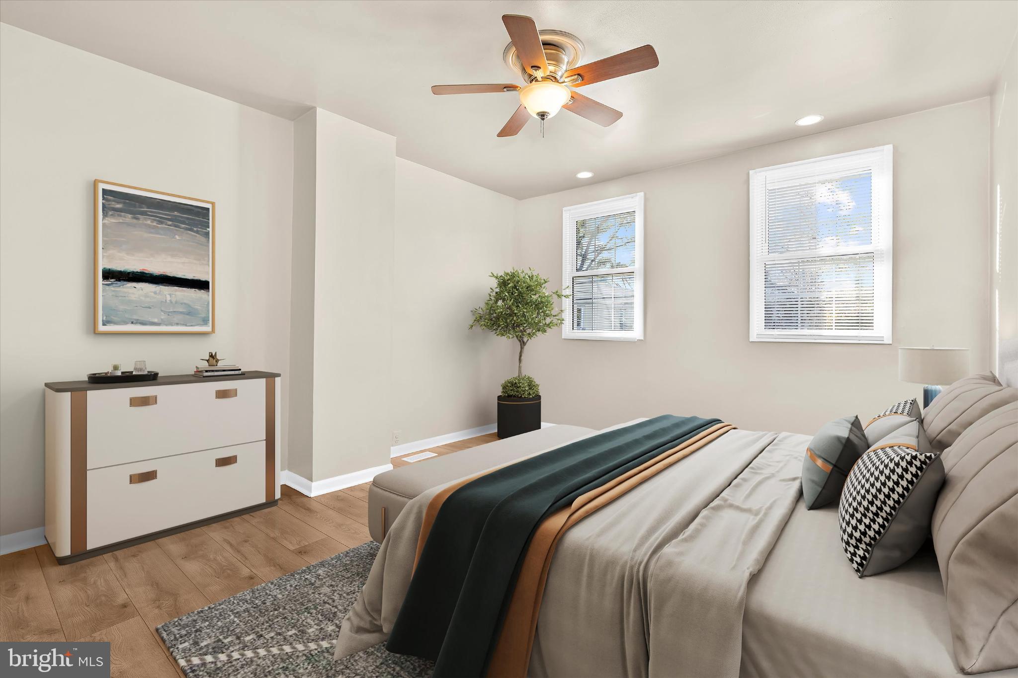 406 Cambria Street Baltimore, MD 21225 - Photo 13 of 26 a bedroom with a bed and a chandelier