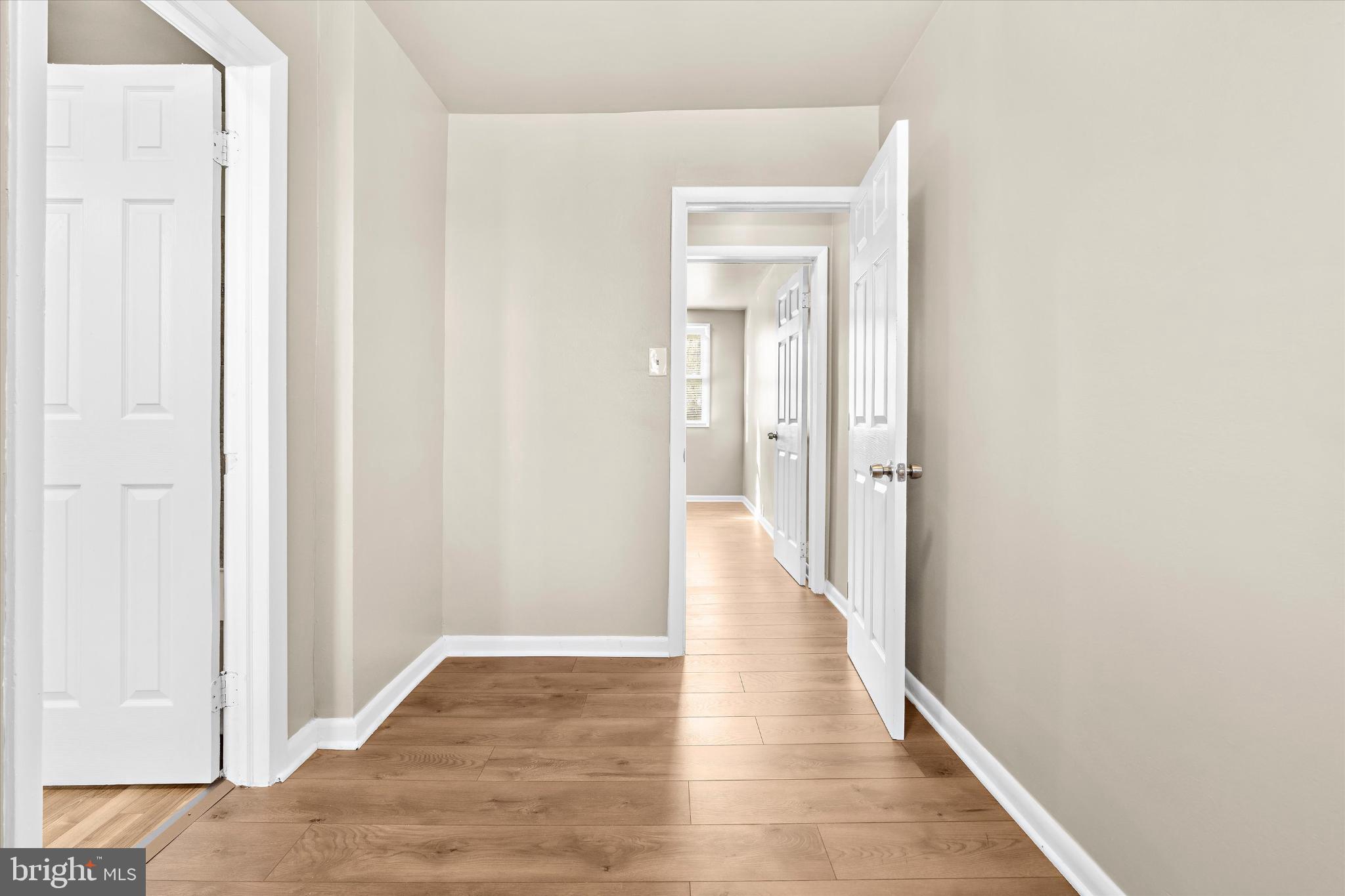 406 Cambria Street Baltimore, MD 21225 - Photo 17 of 26 a view of a hallway with wooden floor