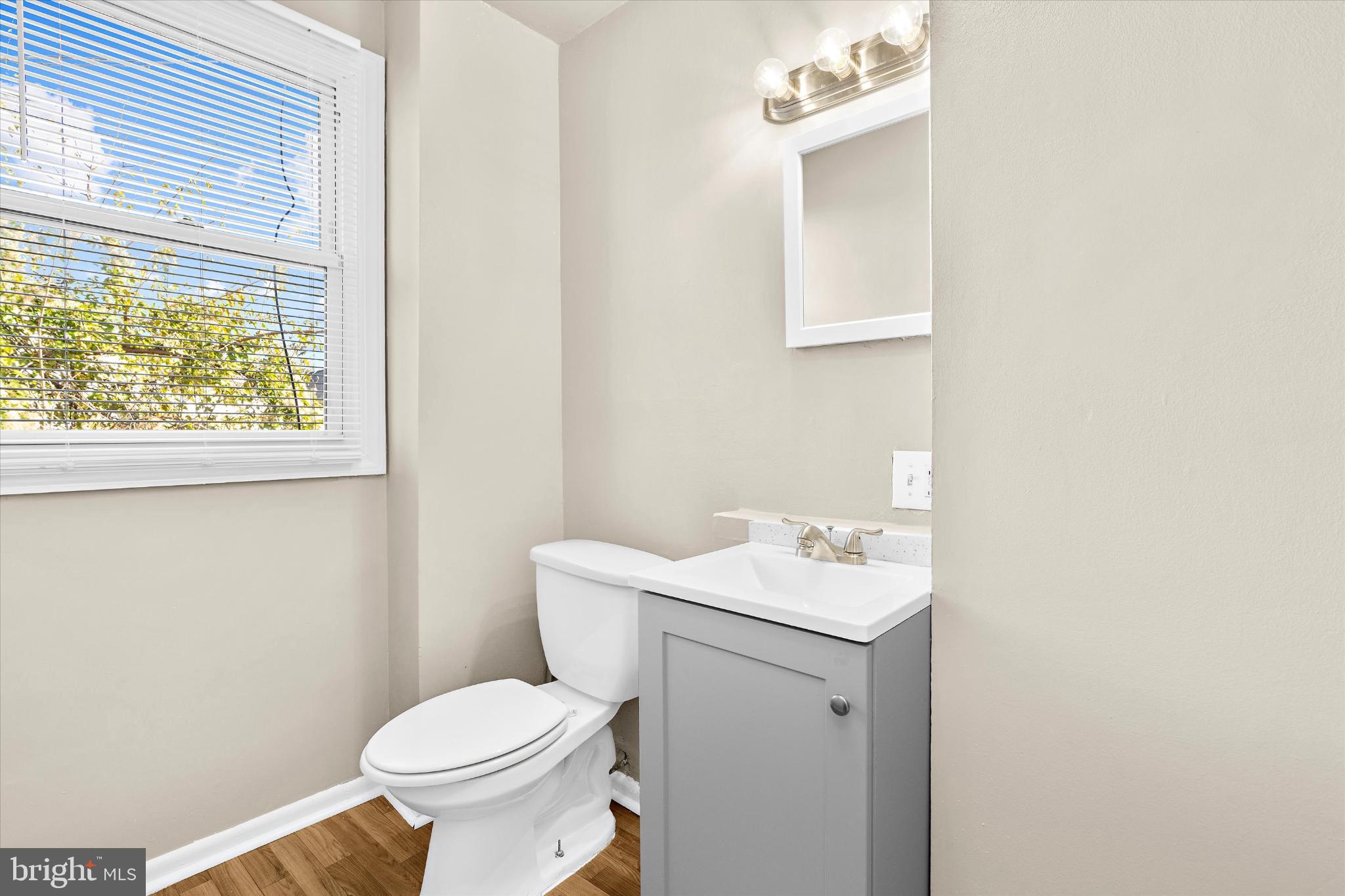 406 Cambria Street Baltimore, MD 21225 - Photo 19 of 26 a white toilet sitting next to a white sink