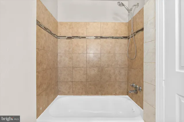 a bathroom with a shower and a bath tub