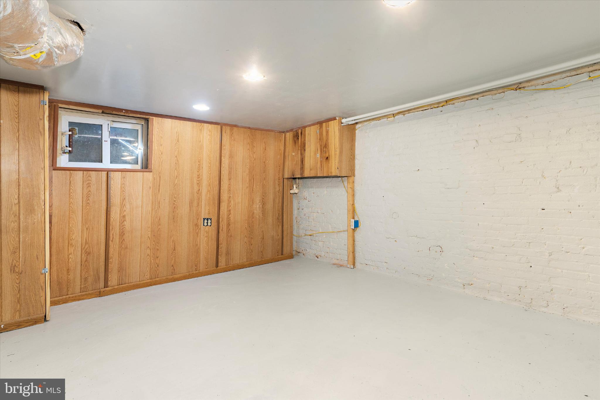 406 Cambria Street Baltimore, MD 21225 - Photo 22 of 26 a view of an empty room with a window