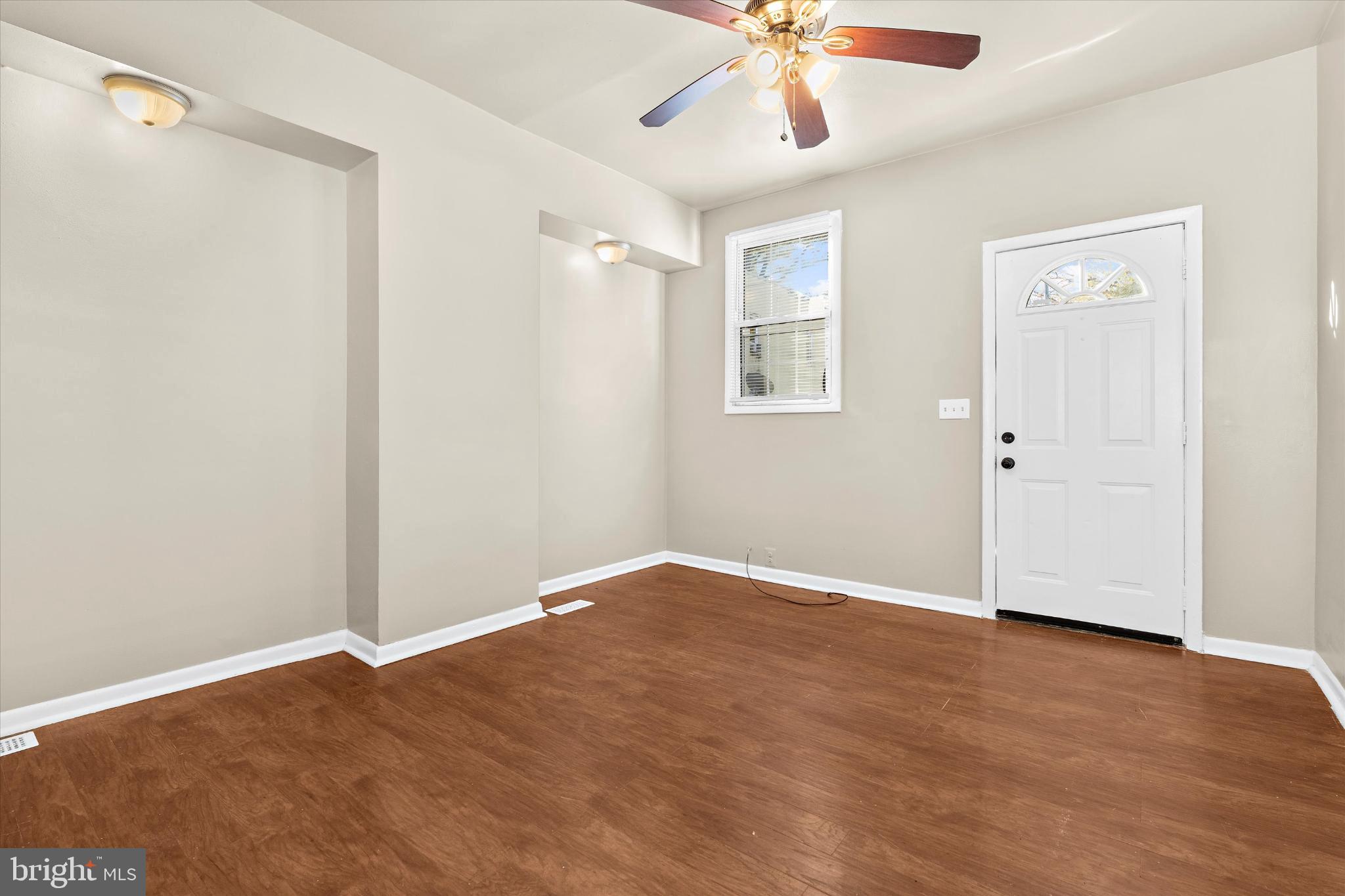 406 Cambria Street Baltimore, MD 21225 - Photo 7 of 26 an empty room with fan and windows