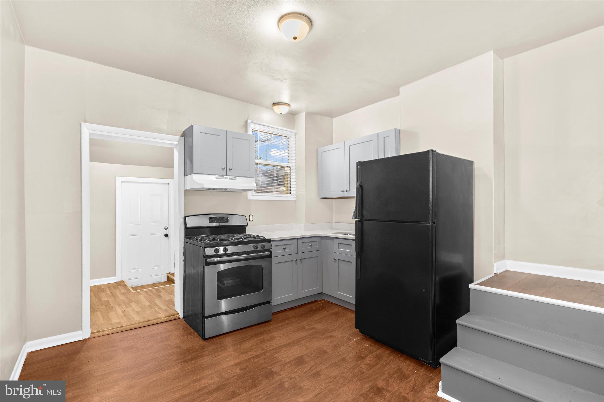 406 Cambria Street Baltimore, MD 21225 - Photo 9 of 26 a kitchen with a refrigerator and a stove