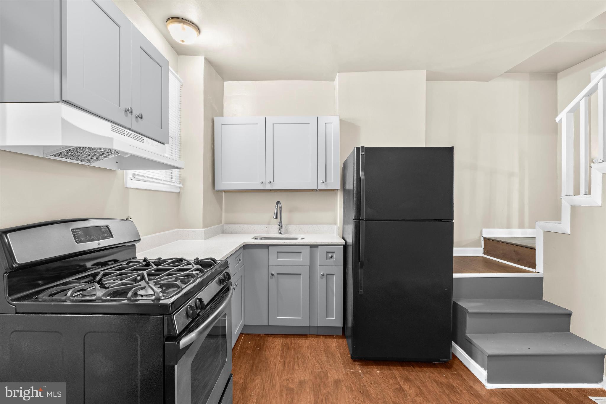 406 Cambria Street Baltimore, MD 21225 - Photo 10 of 26 a kitchen with a stove a refrigerator and a sink
