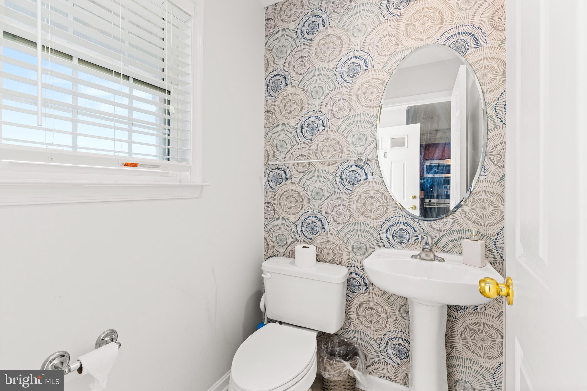 617 Salt Spray Road, Unit B Ocean City, MD 21842 - Photo 29 of 72 a bathroom with a toilet and a sink
