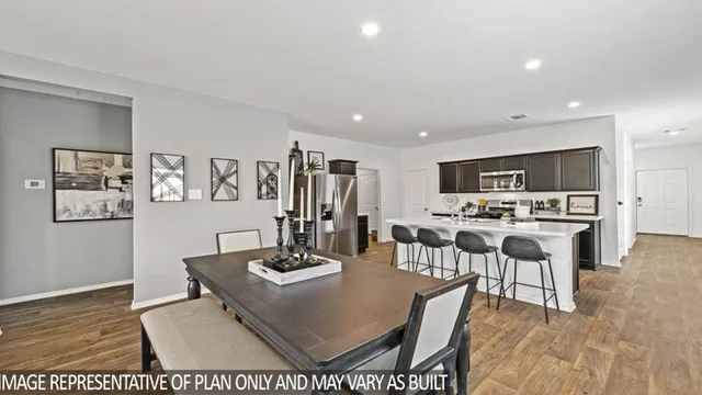 a living room with stainless steel appliances kitchen island granite countertop furniture and view of kitchen