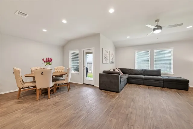 a living room with furniture and a wooden floor
