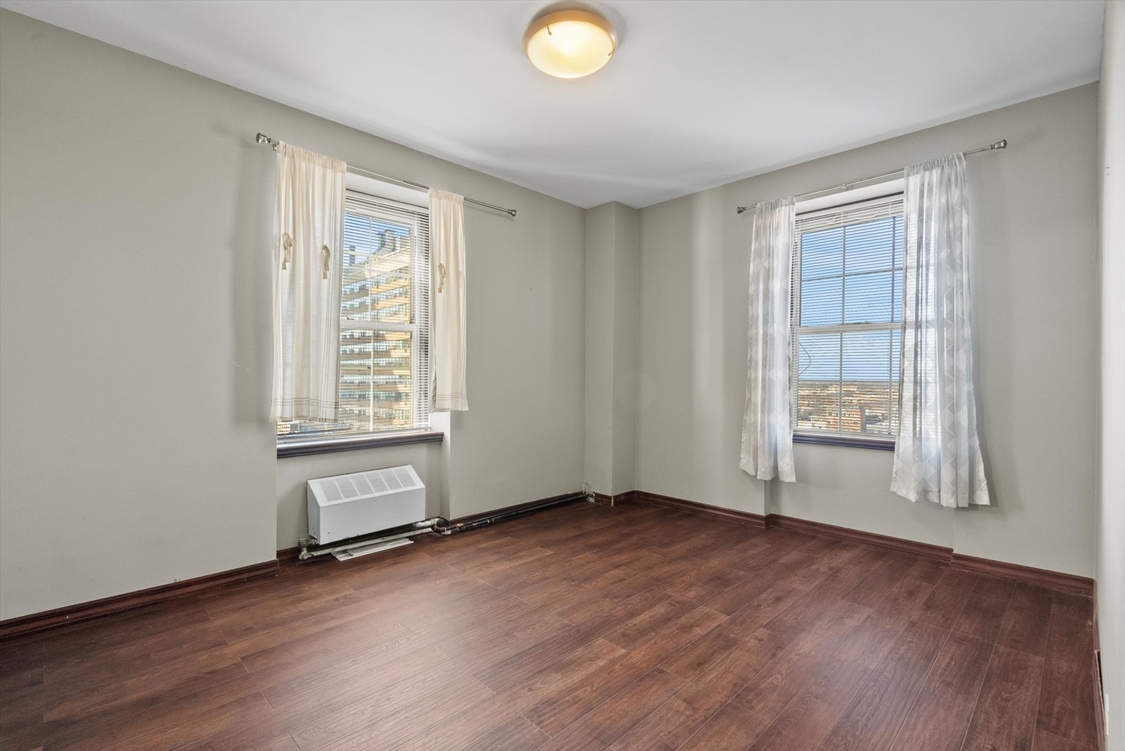 6101 North Sheridan Road, Unit 14C Chicago, IL 60660 - Photo 14 of 20 an empty room with wooden floor and windows