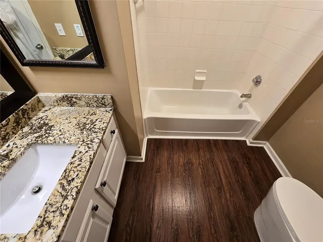 an empty room with fireplace and windows