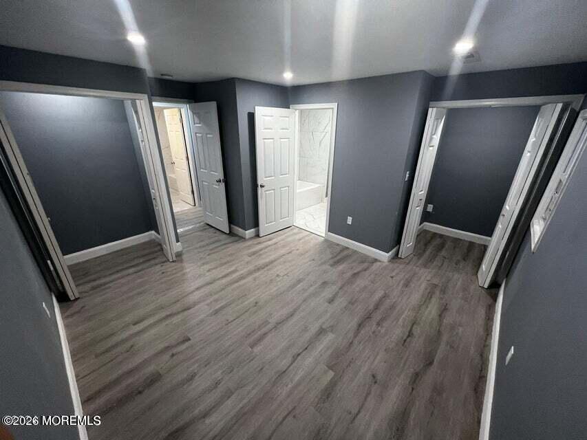 6611 Magnolia Drive Millville, NJ 08332 - Photo 9 of 14 an empty room with wooden floor and windows