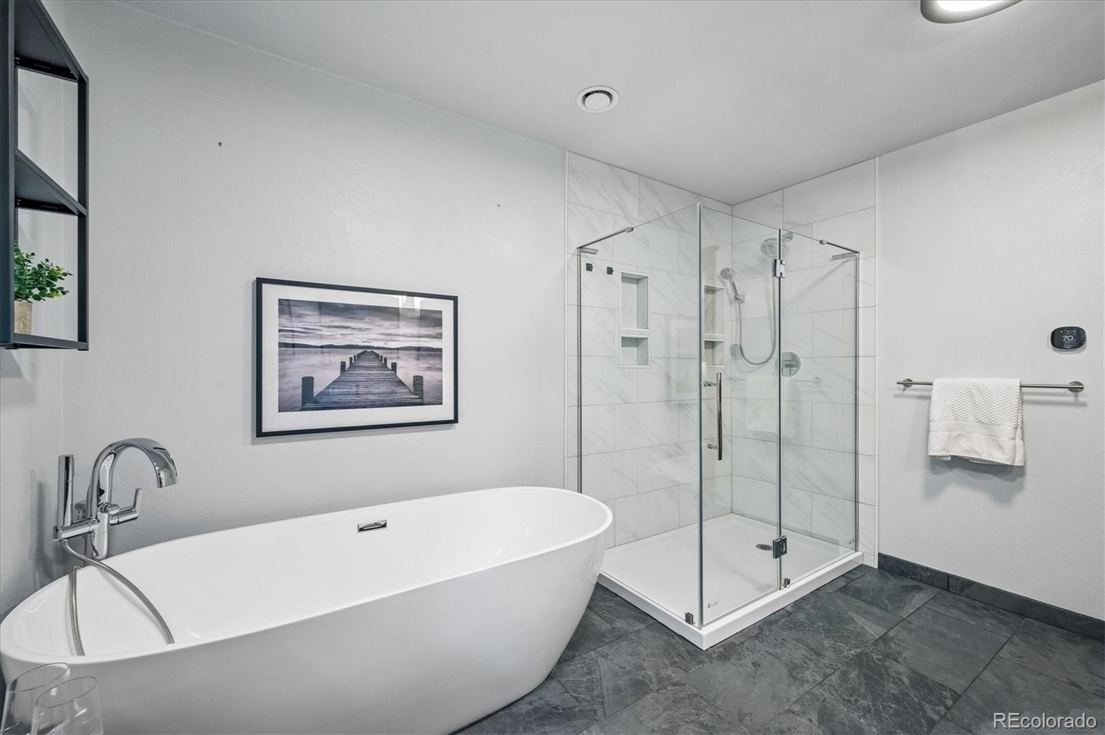 6747 South Brook Forest Road Evergreen, CO 80439 - Photo 24 of 49 a bathroom with a bathtub and a shower