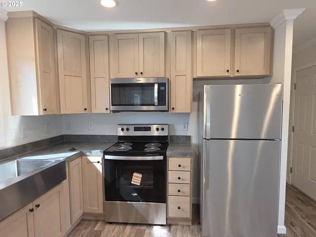 a kitchen with a refrigerator stove and microwave