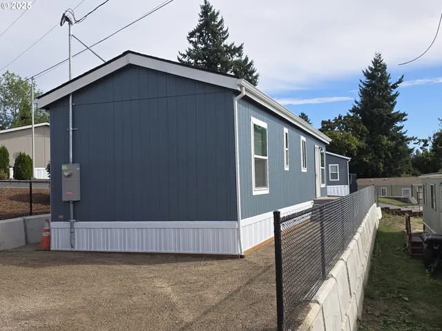 a view of a house with wooden fence