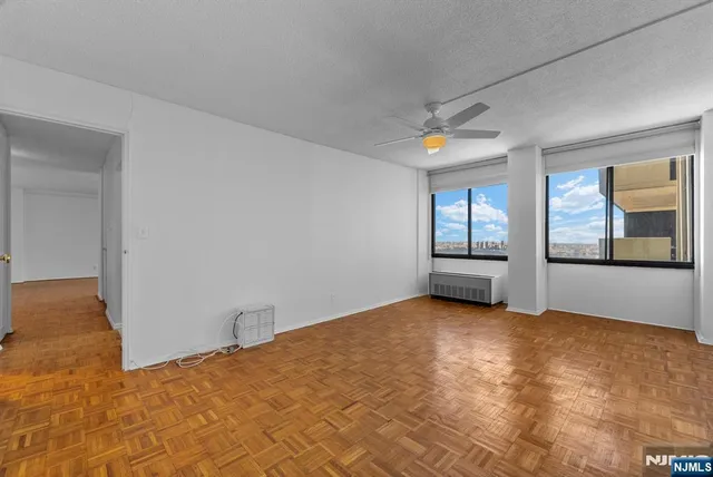 an empty room with windows and closet