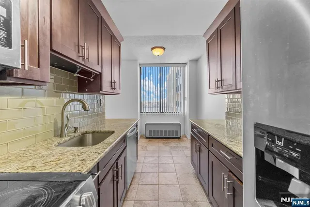a kitchen with a sink stove top oven and cabinets