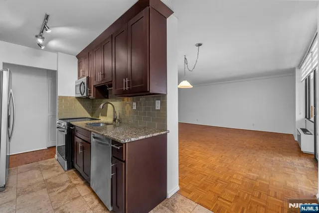 a kitchen with granite countertop a stove and a sink