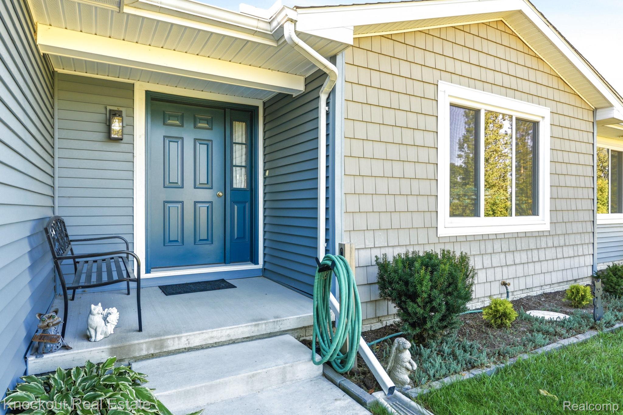 5727 Mackinaw Road Saginaw, MI 48604 - Photo 7 of 60 Entryway with a paneled door, sidelight, and exterior lighting fixture
