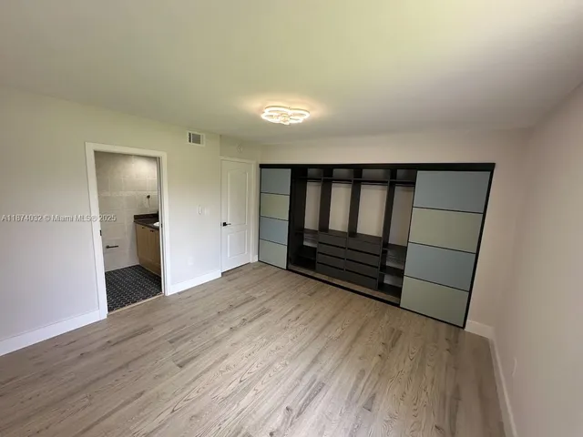 a view of wooden floor and windows in a room