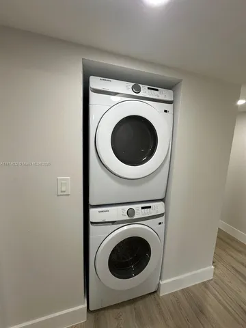 a view of a hallway with washer and dryer