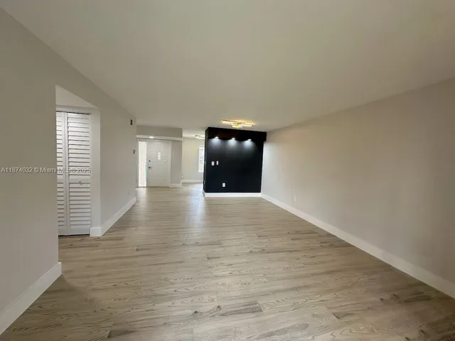 a view of an empty room and wooden floor