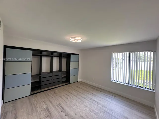 a view of wooden floor and windows in a room