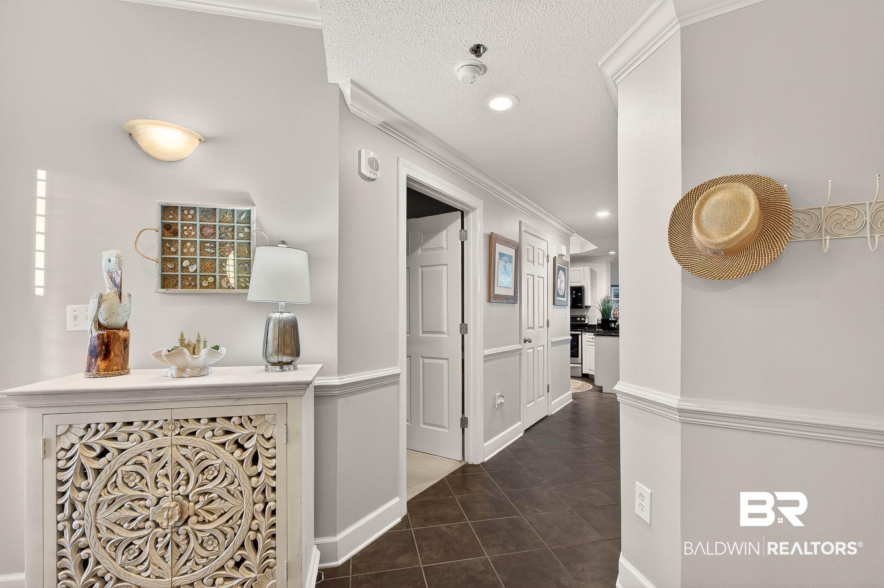 27582 Canal Road, Unit 2507 Orange Beach, AL 36561 - Photo 10 of 75 Hall featuring ornamental molding, dark tile patterned flooring, a textured ceiling, and recessed lighting