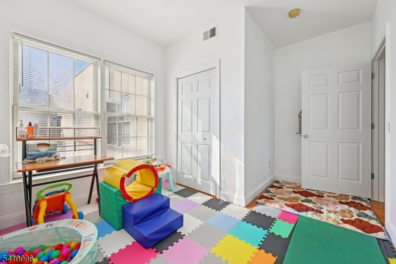15 Tichenor Street, Unit 407 Newark, NJ 07114 - Photo 20 of 25 a bed room with a bed and a window