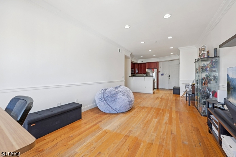 15 Tichenor Street, Unit 407 Newark, NJ 07114 - Photo 9 of 25 a living room with furniture and wooden floor