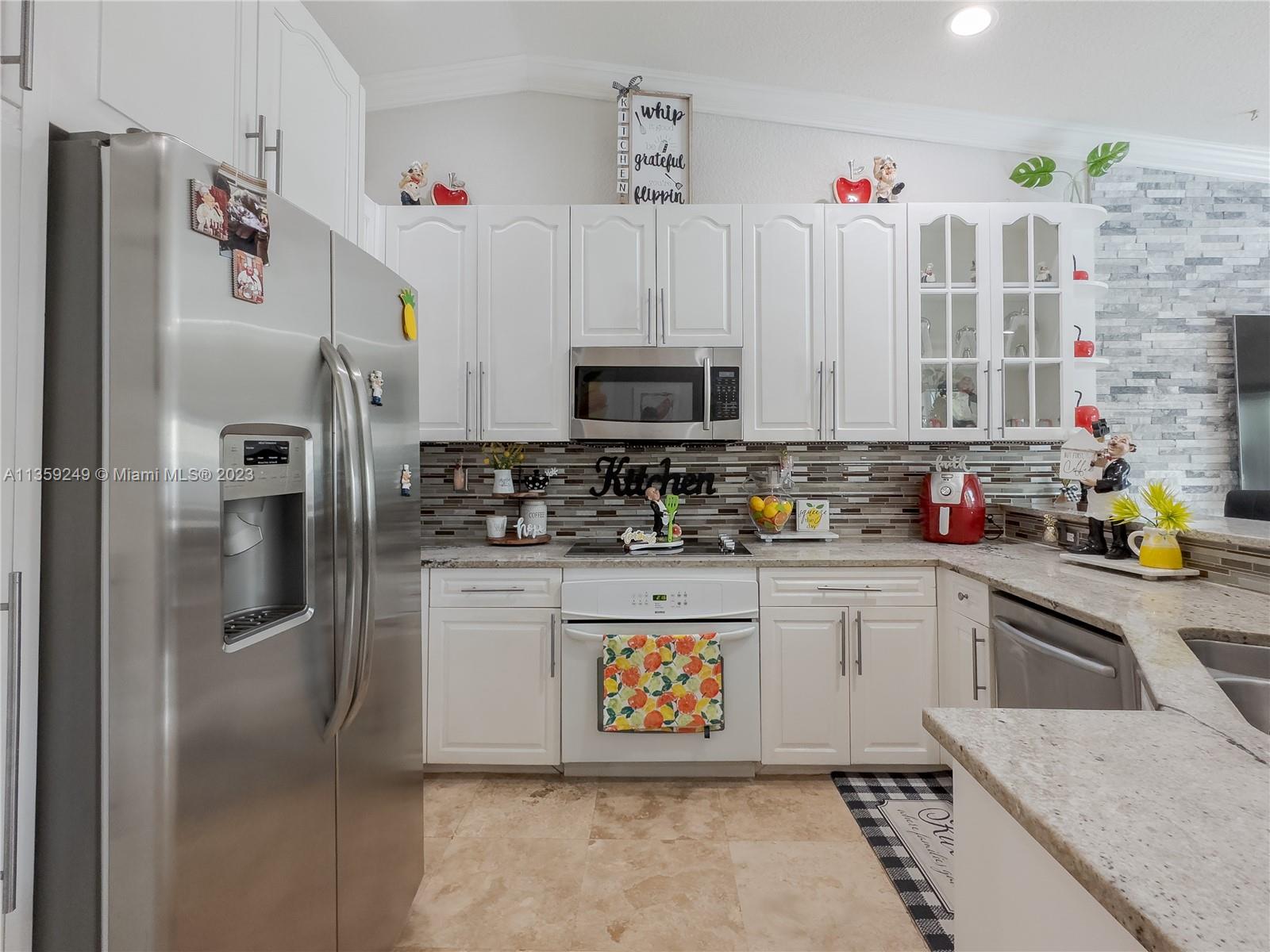 Kendale Lakes Miami, FL 33175 - Photo 11 of 39 a kitchen with stainless steel appliances granite countertop a refrigerator sink and microwave
