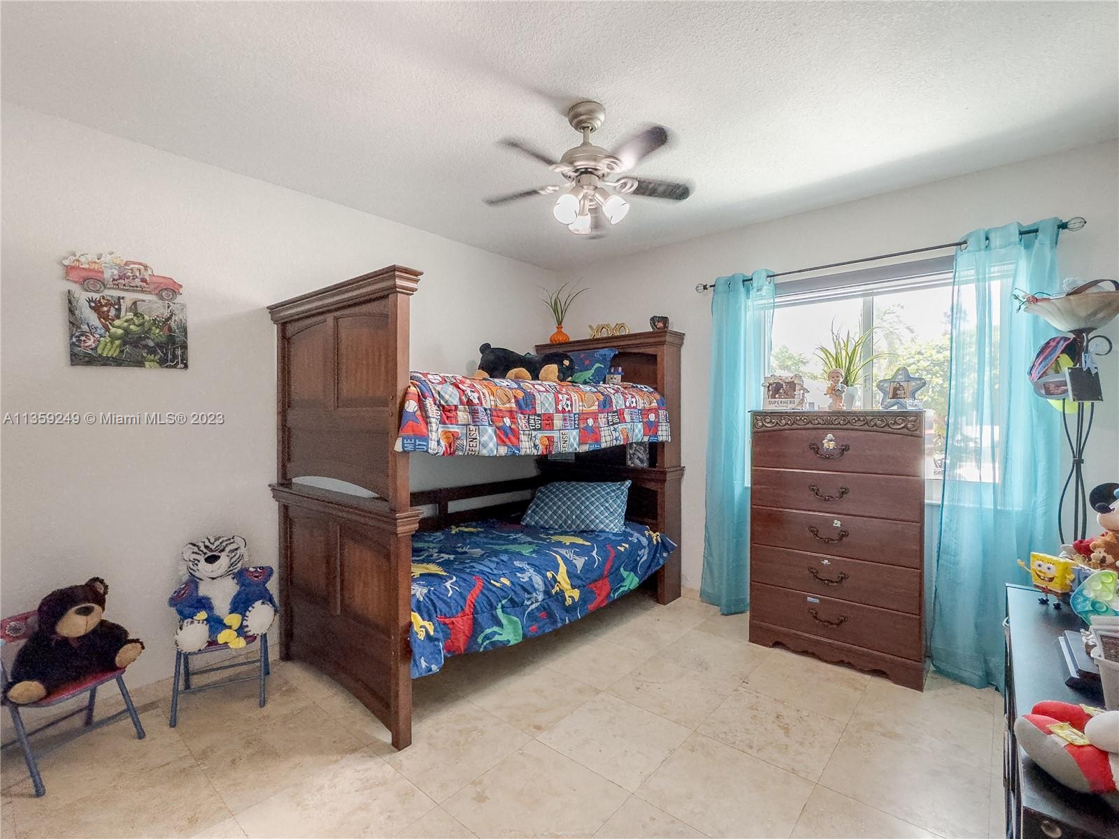Kendale Lakes Miami, FL 33175 - Photo 18 of 39 a bedroom with a bed and a baby crib