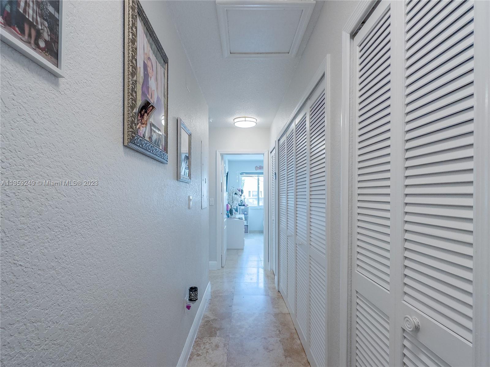 Kendale Lakes Miami, FL 33175 - Photo 20 of 39 a view of a hallway with wooden floor and closet