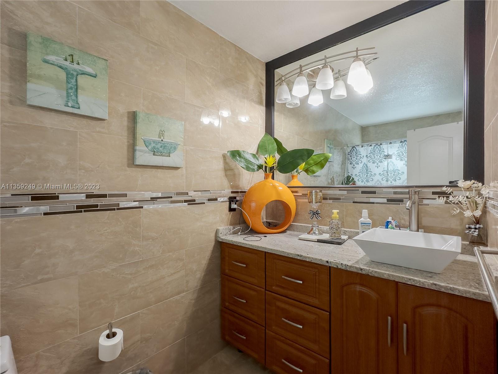 Kendale Lakes Miami, FL 33175 - Photo 24 of 39 a bathroom with a granite countertop sink a mirror and shower