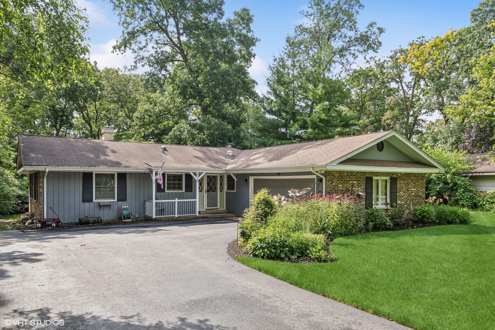 713 Hickory Road Woodstock, IL 60098 - Photo 1 of 13 a house with a tree in front of it