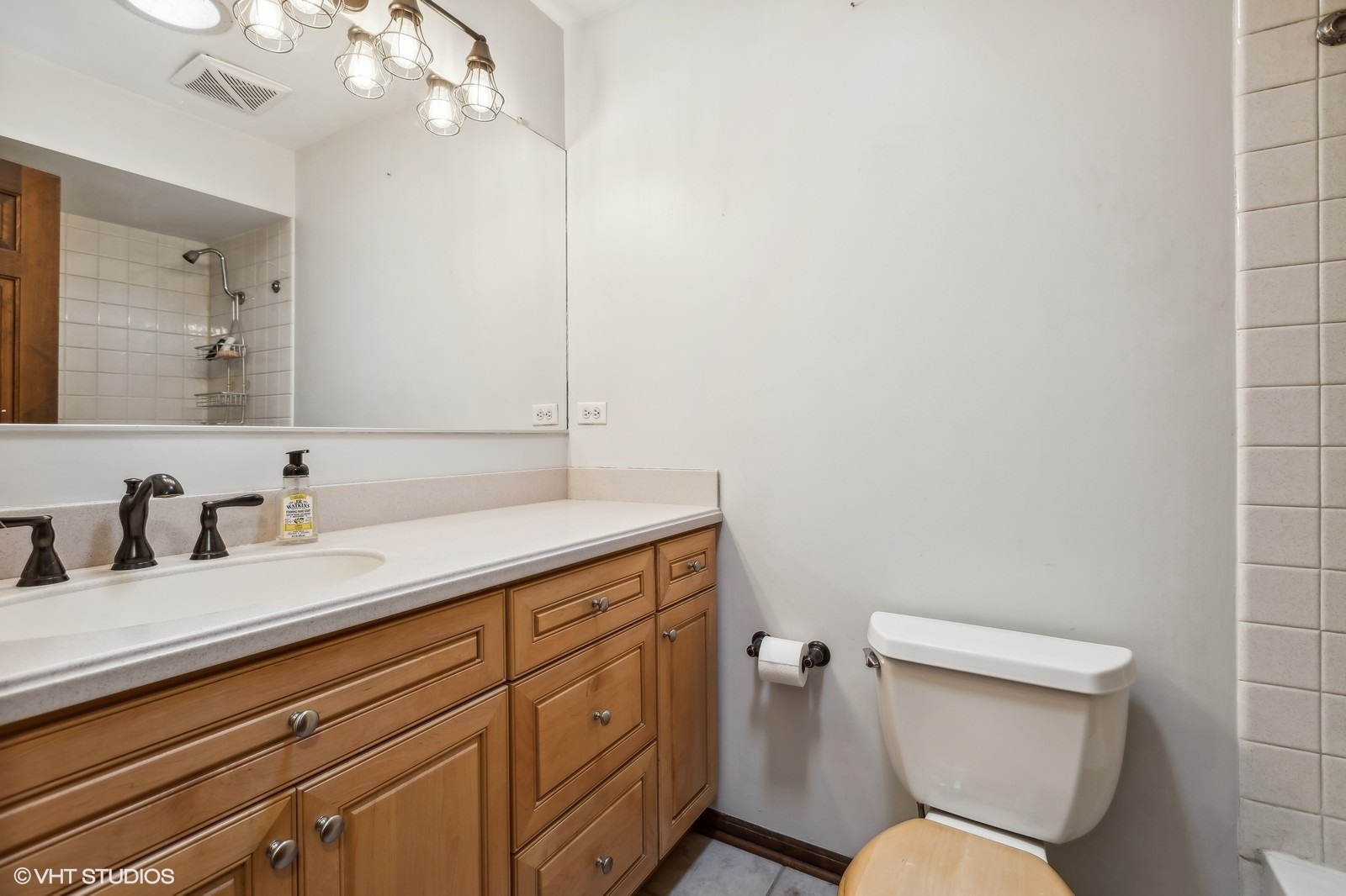 713 Hickory Road Woodstock, IL 60098 - Photo 7 of 13 a bathroom with a granite countertop toilet sink and mirror