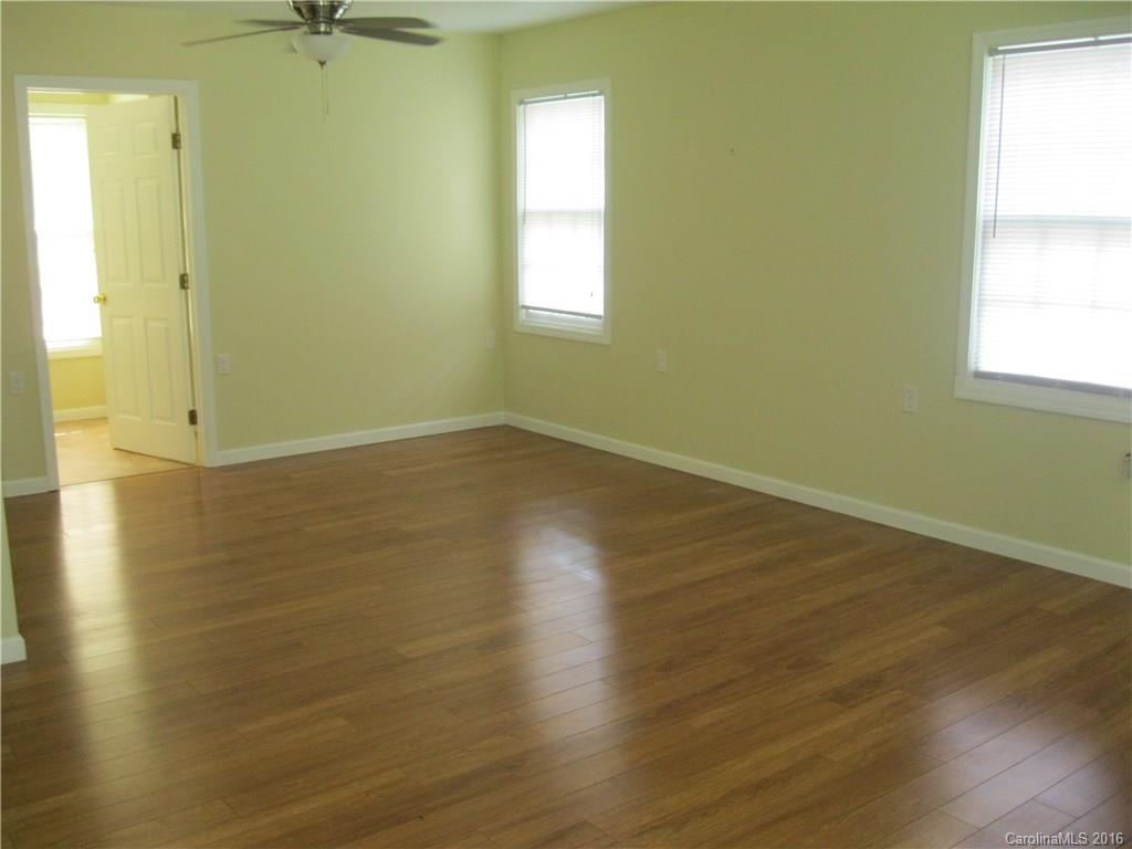 904 Fieldstone Road Mooresville, NC 28115 - Photo 12 of 15 an empty room with wooden floor and windows