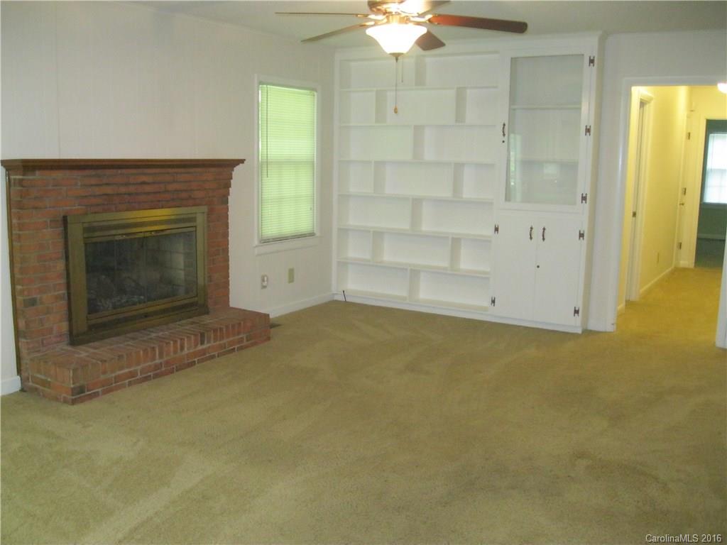 904 Fieldstone Road Mooresville, NC 28115 - Photo 4 of 15 an empty room with a fireplace