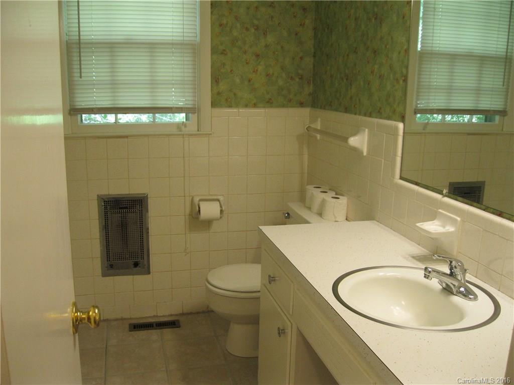 904 Fieldstone Road Mooresville, NC 28115 - Photo 10 of 15 a bathroom with a sink a toilet and mirror
