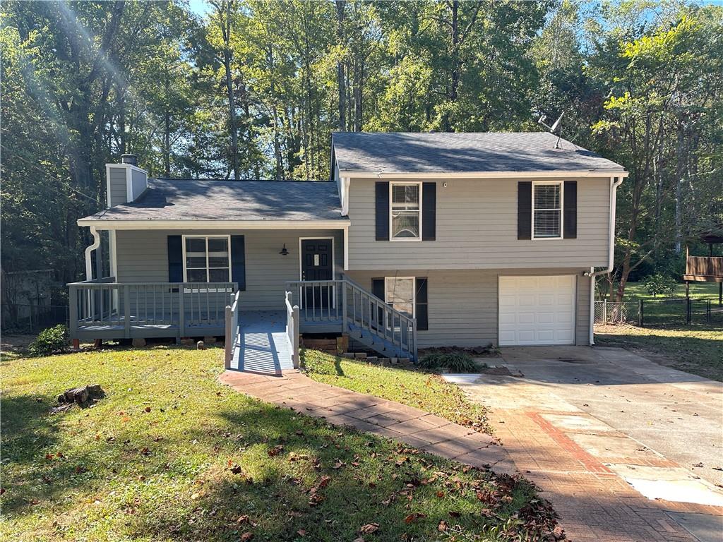 a view of a house with swimming pool and a chairs in patio