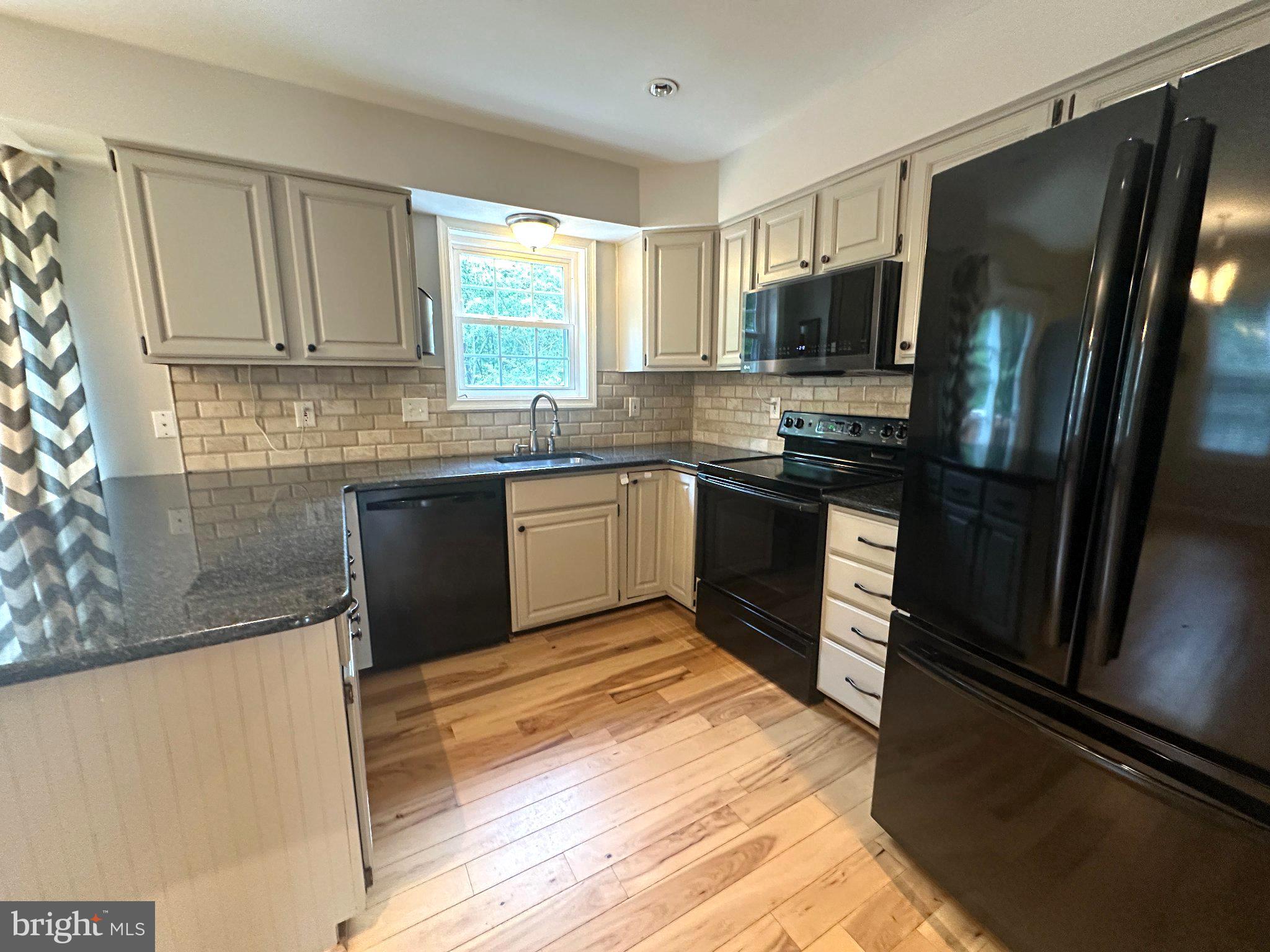 11928 Sentinel Point Court Reston, VA 20191 - Photo 8 of 23 Modern kitchen with sleek finishes.