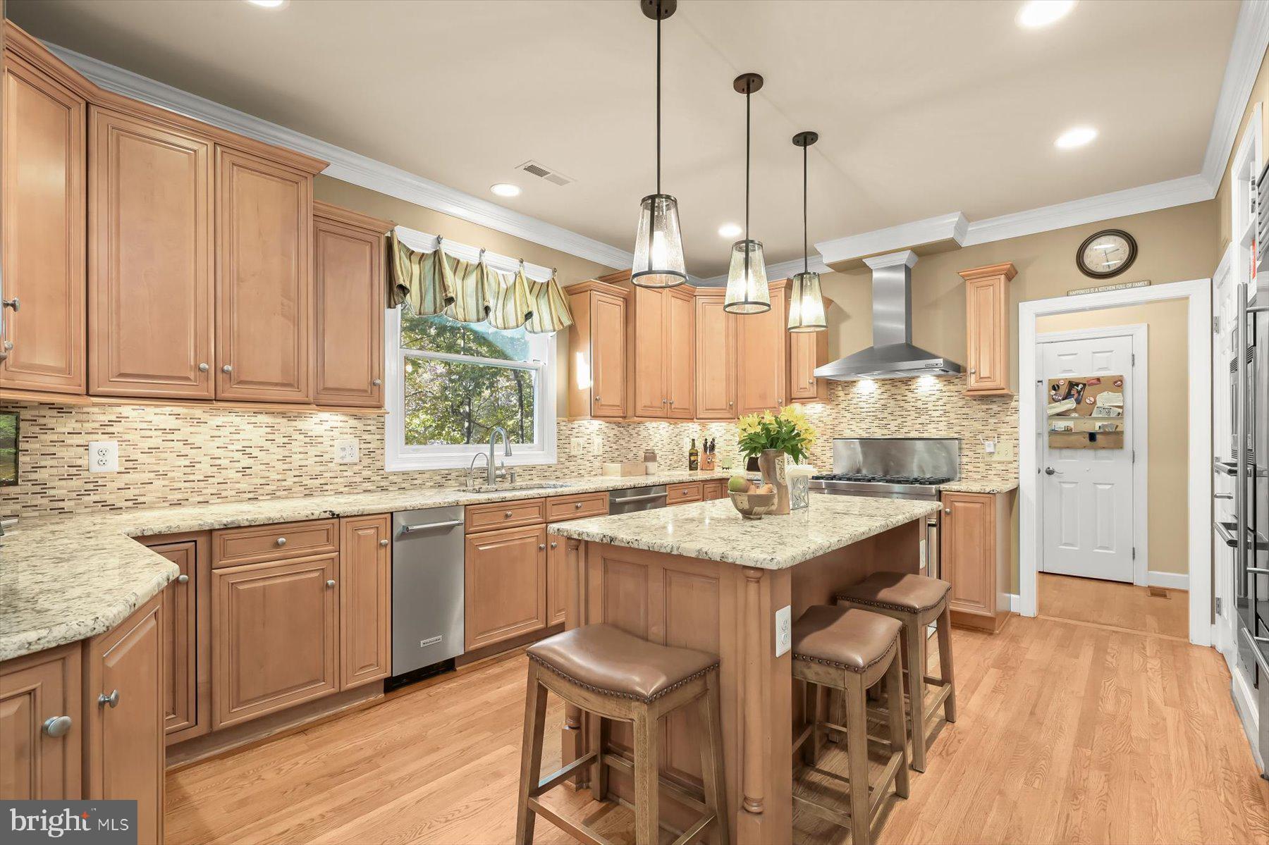 7828 Stable Way Potomac, MD 20854 - Photo 12 of 60 a kitchen with granite countertop a sink cabinets and wooden floor