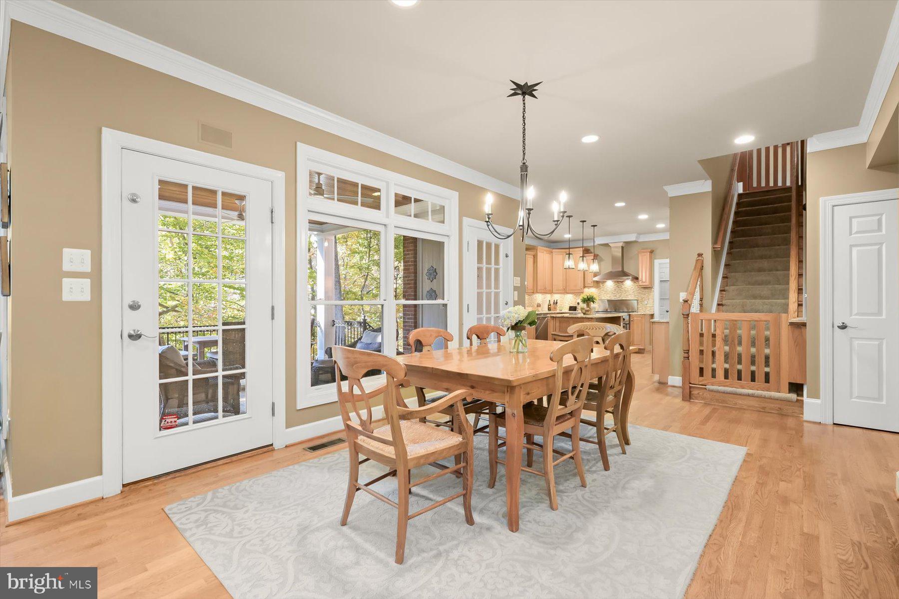 7828 Stable Way Potomac, MD 20854 - Photo 16 of 60 a dining room with furniture a chandelier and wooden floor