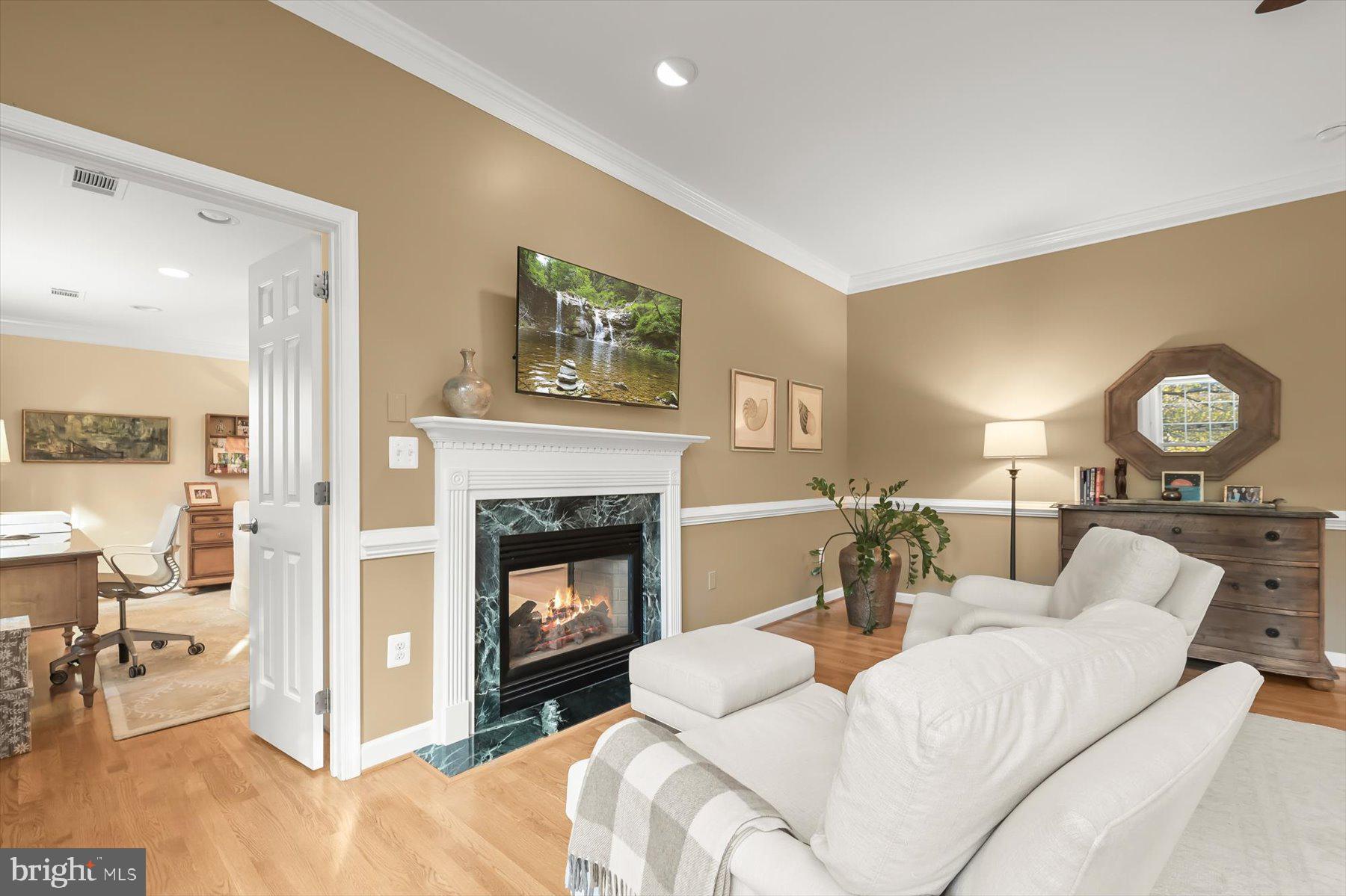 7828 Stable Way Potomac, MD 20854 - Photo 29 of 60 a living room with furniture a clock and a fireplace