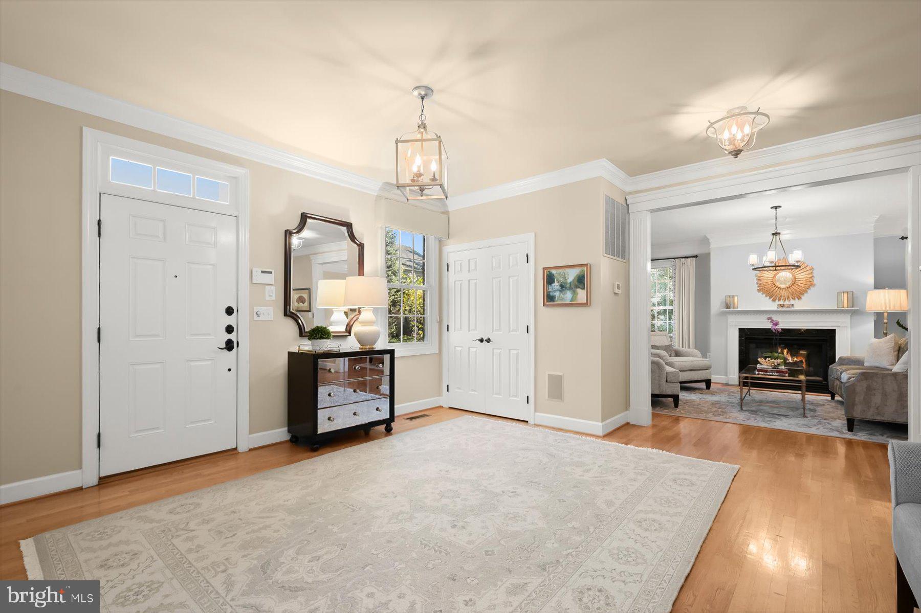 7828 Stable Way Potomac, MD 20854 - Photo 3 of 60 a living room with furniture and a chandelier