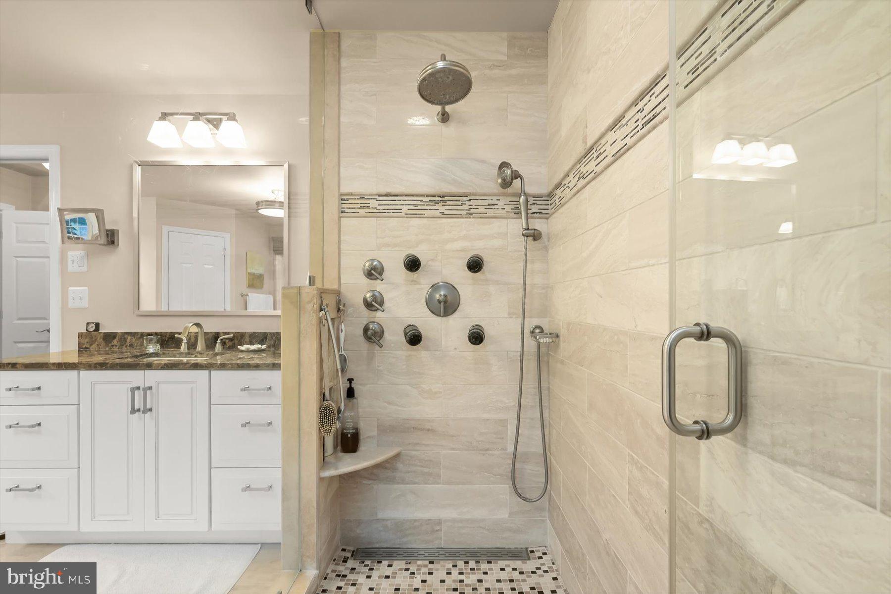 7828 Stable Way Potomac, MD 20854 - Photo 33 of 60 a bathroom with a granite countertop shower a sink and a mirror